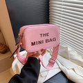 Pink camera bag with The Mini Bag print and patterned wide strap in a textured finish - Pink