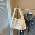 White corduroy drawstring shoulder bag with textured stripes and black brand label - Off-white