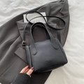 Elegant black lychee grain bucket bag with dual handles and golden hardware detail - Black without Pendant