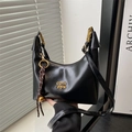 Chic black hobo crescent shoulder bag with gold hardware and logo in soft sunlight - Black With Pendant