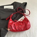 Red bow tie dumpling bag in faux leather with silver eyelets and Y2K aesthetic style - Red
