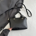 Minimalist black glossy leather bucket bag with FASHION embossing and golden hardware - Black