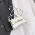 Minimalist white satchel featuring elegant wavy flap design and gold chain accents - White