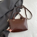 Minimalist dark brown leather bucket bag with top handle and adjustable shoulder strap - Brown