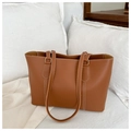 Detail of brown tote bag featuring white contrast stitching and gold metal buckles - Tan