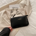 Minimalist black pebbled leather crossbody bag with silver chain and stud details - Black
