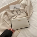 Chic beige crossbody square bag with gold FASHION text and rivet details on stylish backdrop - White