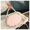 Detail van roze schelptas met parelhandvat en geplooide PU-lederen oppervlaktestructuur - Roze