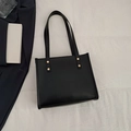 Classic black leather tote bag with elegant gold studs and a sleek minimalist design - Black