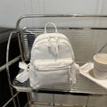 White corduroy mini backpack for women featuring front zipper pocket and adjustable straps - White