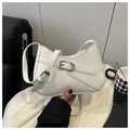 Close-up of white minimalist hobo bag with silver buckle and adjustable shoulder strap - White