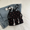 Black corduroy backpack with red strawberry print and white tassel drawstring detail - Black