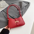 Chic red leather underarm bag with gold buckle and thin knotted straps in minimalist style - Red