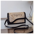 Detailed macro view of the Chinese style jacquard fabric and black leather trim on bag - Black