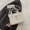 Chic white square handbag with lychee texture and golden deer pendant in 45-degree angle - White