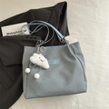 Light blue twill tote bag with chain strap and cloud plush charm in casual flat lay - Blue with Pendant