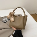 Chic khaki bucket bag in litchi grain leather featuring a decorative plaid scarf handle - With Pendant / Khaki