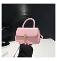 Detail shot of light pink PU leather handbag featuring elegant gold metal clasp closure - Pink