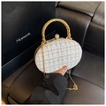 Detail view of tweed evening clutch with gold chain strap and sparkling crystal clasp - White