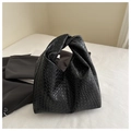 Detail of minimalist black woven leather hobo bag with a signature knotted handle - Black