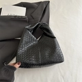 Chic black woven leather shoulder bag with knotted handle detail for a trendy look - Black