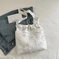 White bucket bag featuring colorful wave embroidery and a drawstring closure - White