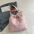 Pink quilted bucket bag with colorful wavy embroidery and adjustable woven strap - Pink