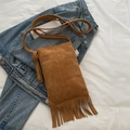 Brown faux suede crossbody bag featuring long tassels and a bohemian-style fringe design - Brown