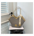 Close-up of houndstooth tote bag with V-cut edge and golden fashion brand logo - Khaki