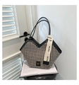 Detail of houndstooth tote bag featuring a V-shaped opening and stylish webbing strap - Black