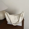Large cream dumpling shoulder bag with lychee texture leather on minimalist desk - White