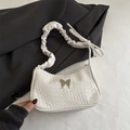 White woven underarm bag with silver metal butterfly and ruffled strap detail - White