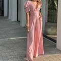 Pink V-neck jumpsuit with puff sleeves and wide-leg trousers on a model in sunlight - Pink