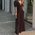 Elegant black deep V-neck jumpsuit with puff sleeves and wide legs on a model - S / Black