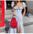 Detail of floral square neck dress with drawstring bust and puff sleeves in street setting - S / White Blue