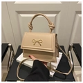 Detail of beige small square bag with golden bow buckle and knotted handle - Khaki