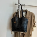 Black woven shoulder bag with large capacity featuring gold bell and stripe charm accessory - Black With Pendant
