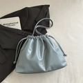 Light blue soft leather drawstring bucket bag with silver metal bow detail and shoulder strap - Blue