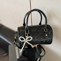 Vintage black snake-skin barrel handbag featuring elegant pearl bow charm and shoulder strap - Black (With Charm)