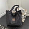 Large black denim tote bag with brown leather patch label and spacious interior - Black