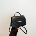Quilted crossbody bag in black leather with gold metal trim and rounded top handle - Black