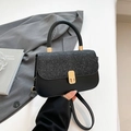 Elegant black crossbody bag with silver glitter flap and gold rotary lock detail - Black