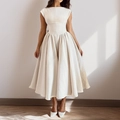 Elegant cream sleeveless midi dress with structured waist and pleated X-line silhouette - S / Apricot