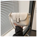 Detail of the white leather shoulder bag featuring a unique knot-design strap and silver U-clasp - White