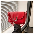Detail of red leather shoulder bag with silver U-shaped metal buckle and decorative knots - Red