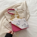 Pink and white crossbody bag with grey butterfly print and golden chain strap detail - Pink