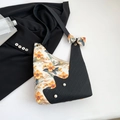 Floral print tote bag with black panel and pearl accents with elegant bow shoulder strap - Black