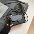 Minimalist crossbody bag with black leather body and grey textured woven flap design - Black