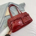 Dark red patent leather shoulder bag featuring bow accents and pleated pockets - Red