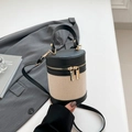 Elegant black and white contrast cylinder bucket bag in woven canvas and leather finish - Black